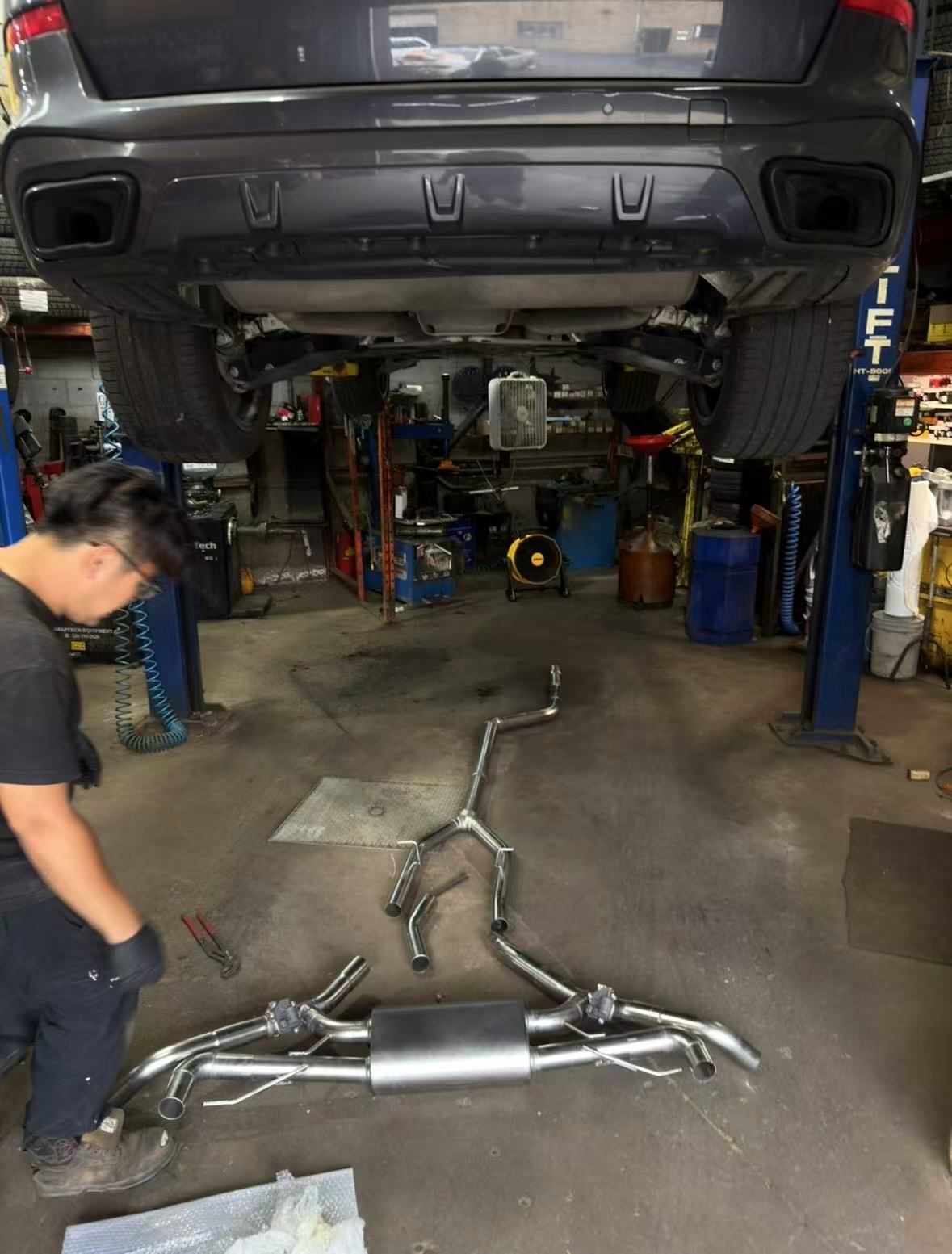 BMW X5 40i exhaust being installed